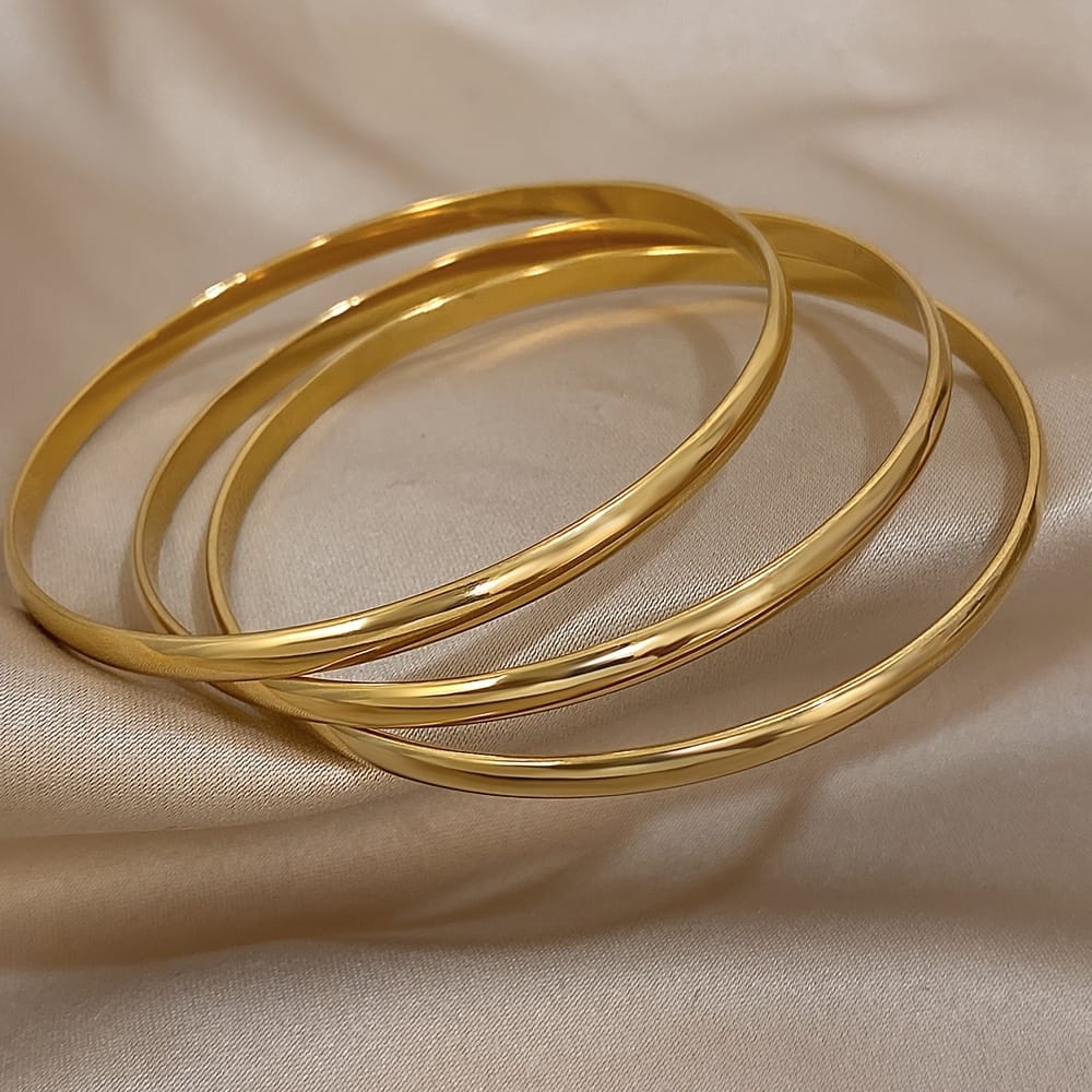 Set Of Multiple Stainless Steel Bangles With A Glossy Curved Design, Including 3pcs Of Golden Bracelets, Suitable For Both Men And Women. Bangle Shop Online at Dubai Trades 2